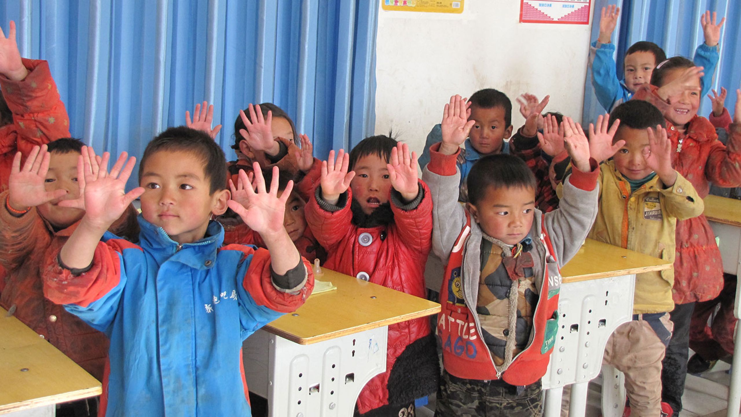 children showing their clean hands after class in TB prevention