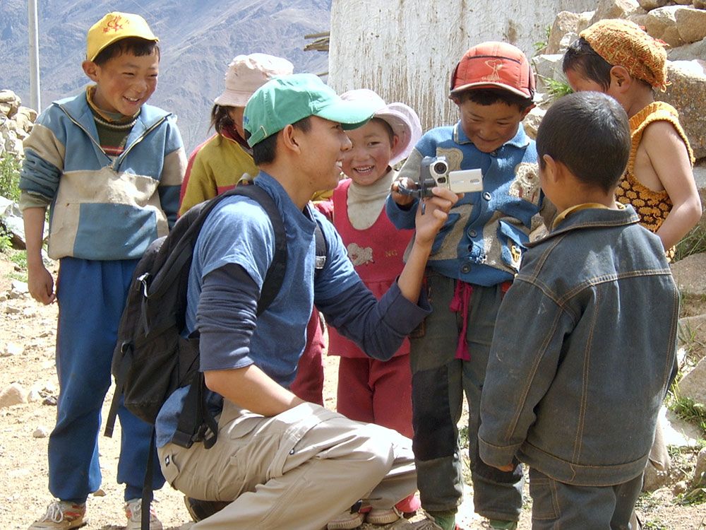 Tibetan children look at video camera